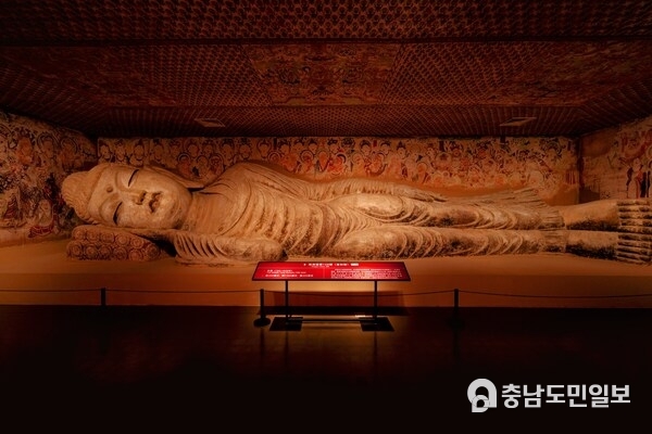 Cave 158, a renowned Nirvana cave in the Mogao Caves, features a 15.8-meter-long Buddha statue with a serene expression and a slight smile.